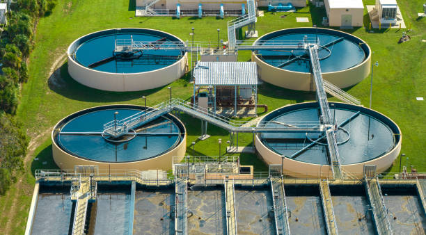 aerial view of water treatment factory at city wastewater cleaning facility. purification process of removing undesirable chemicals, suspended solids and gases from contaminated liquid - sewage pond imagens e fotografias de stock