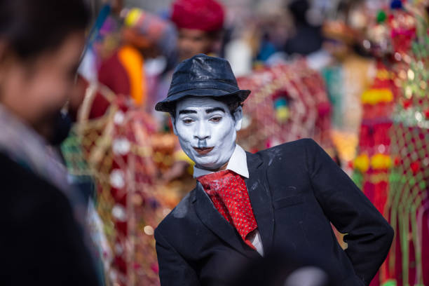 Bikaner, Rajasthan, India - January 2023: Camel festival, Portrait of an male artist with painted face and fantasy look  in historical character while participating in camel festival parade at bikaner. Selective focus.