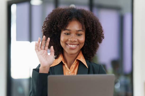 istock Beautiful American women smiling and using video call application on laptop 1467040512
