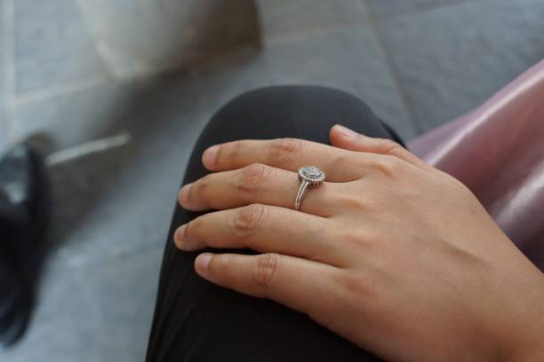 istock Close up of hand on lap wearing silver diamond ring 1467042015