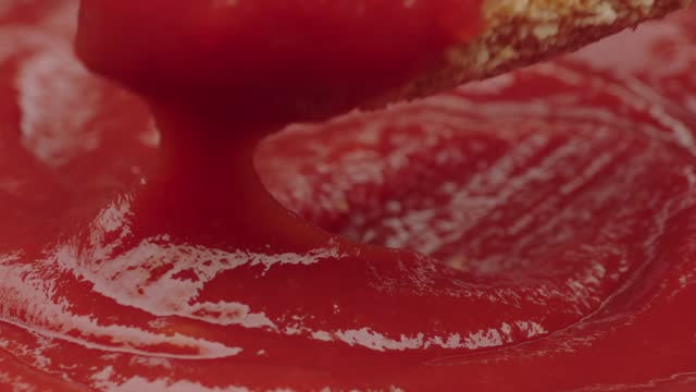 passing chicken nuggets in ketchup in slow motion with zoom in