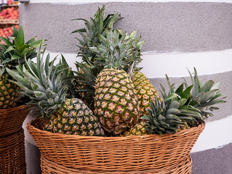 Pineapples in a basket at the store.
