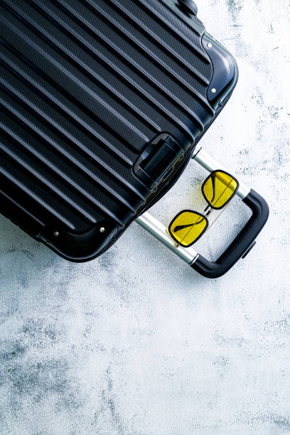 istock Black travel bag,Black luggage set on dark background, top view image, flat lay composition. Travel minimalist concept, black and dark classic baggage mockup, small and big. Suitcase accessory set, journey 1467046880