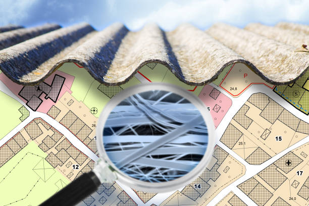 Dangerous asbestos roof with airborne fibers seen through a magnifying glass and microscope - concept with an imaginary city map stock photo