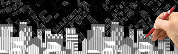 istock Architect or Engineer drawing a residential building over an imaginary city map of territory with buildings, fields and roads 1467049391