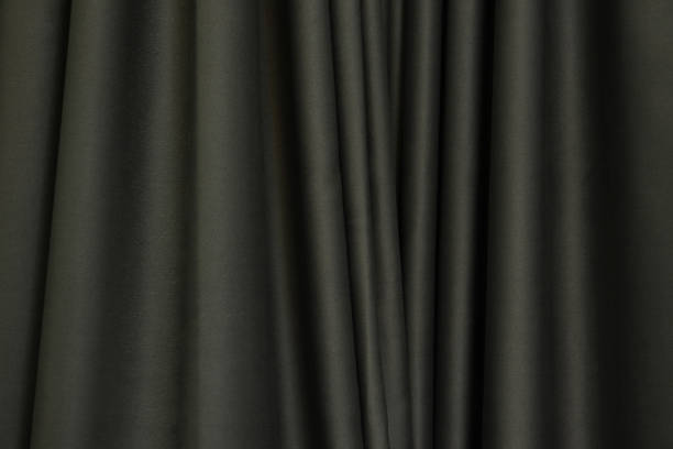 istock Dark brown curtains, folded in wavy, uneven, decorate the house for use as a background image. 1467050858