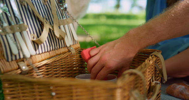 istock Unknown human hands take meal placed in picnic basket outdoors close up. 1467051237