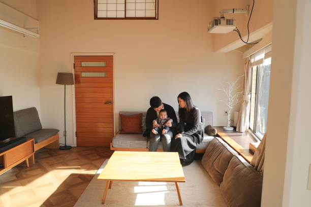 istock Parents relaxing with their baby on the sofa 1467053059