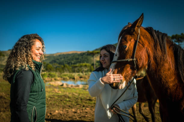 istock women looking at horse 1467054086