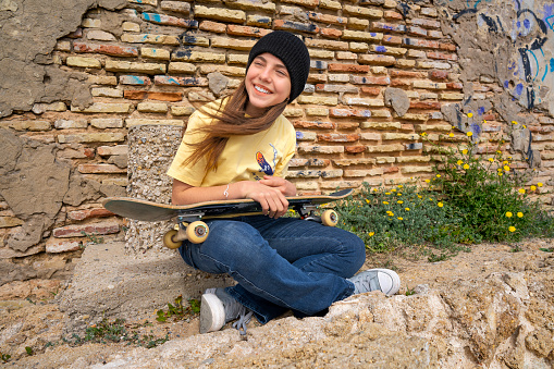 young girl making surf skate and smiling