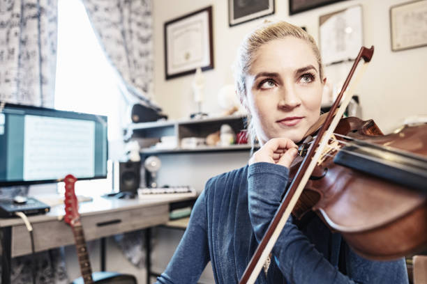istock Female Musician practising at home 1467055306