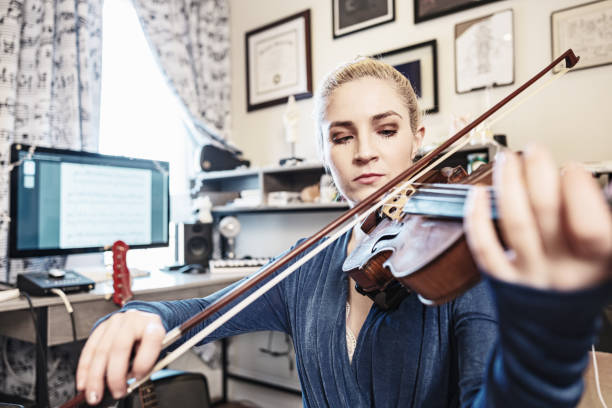 istock Female Musician practising at home 1467055312