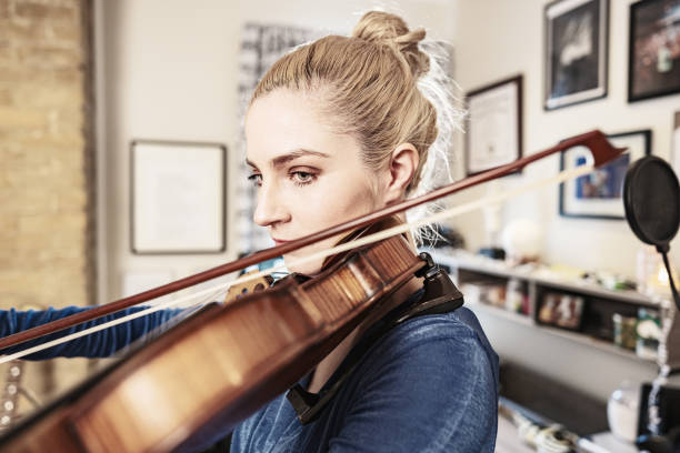 istock Female Musician practising at home 1467055314