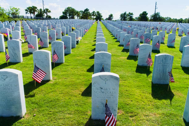 Cape Canaveral, FL, USA, May 30, 2022: Rows of headstones and flags lining up in the Cape Canaveral National Cemetery.