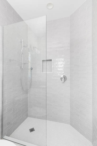 istock A walk-in shower with grey subway and white circular tiles. 1467058899
