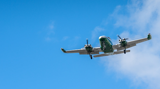Private green airplane taking off from Miami International Airport.