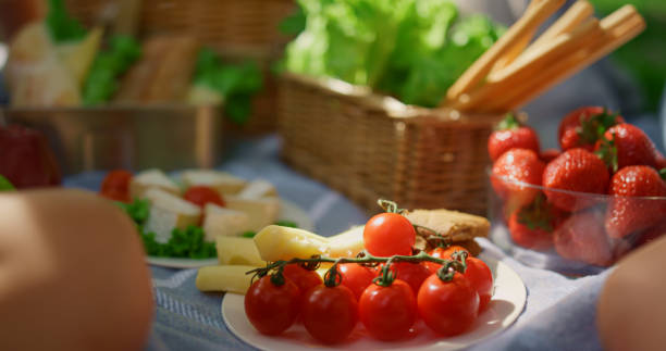 istock Unknown hands take snacks from picnic blanket closeup. Tasty breakfast on nature 1467061112