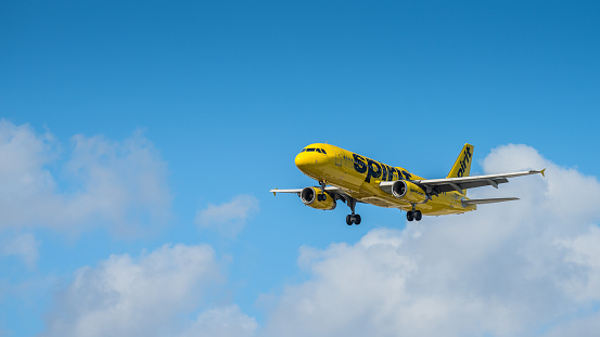 Miami, United States - February 16, 2023: Spirit aircraft (A320) approaching the runway of Miami International Airport. Spirit Airlines, Inc., is an American ultra-low-cost carrier headquartered in Miramar, Florida, in the Miami metropolitan area.