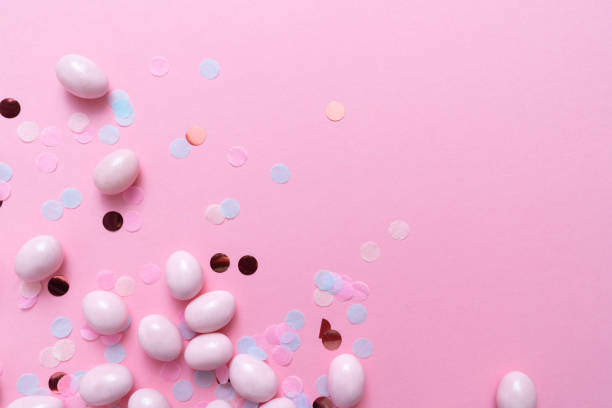 istock Bunch of candy eggs on pink background. Minimal Easter concept with copy space for text. Festive day backdrop. Flat lay style 1467069321