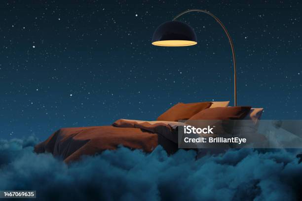 3d Rendering Of Cozy Bed Illuminated By Lamp The Bed Flying Over Fluffy Clouds At Night Stock Photo - Download Image Now