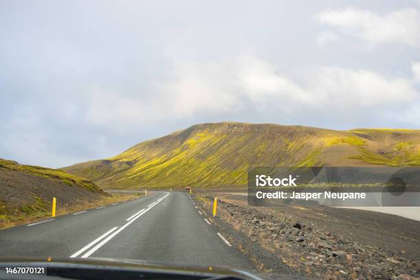 Beautiful Reflection Of Houses Church Highway And Rainbow Road In Seydisfjordur Town In Iceland Stock Photo - Download Image Now