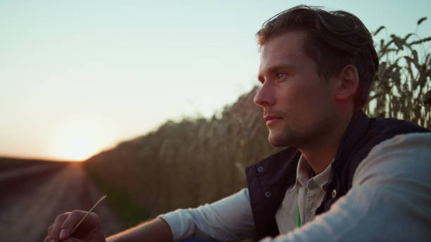 istock Portrait farmer owner looking in camera. Confident agrarian rest at sunset. 1467071441