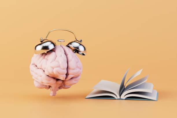 istock time to learn. a brain with an alarm clock next to an open book on a pastel background. 3D render 1467074937