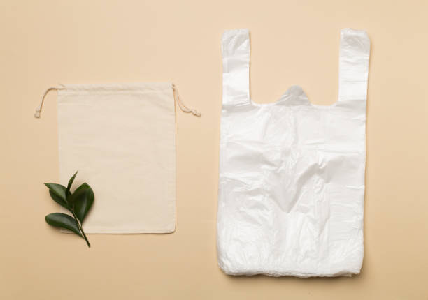istock Plastic and fabric bag on color background, top view. Biodegradable products concept 1467075877