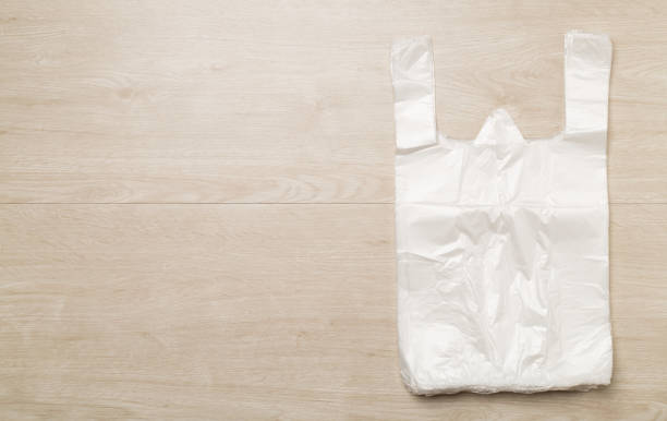 istock Plastic bag on wooden background, top view 1467075893