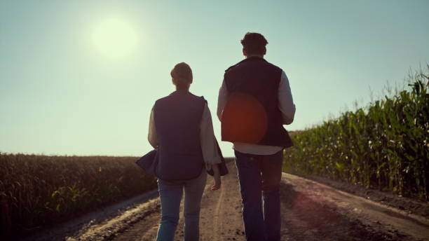 istock Agronomists team going ground road rear view. Agricultural industry workers. 1467076790