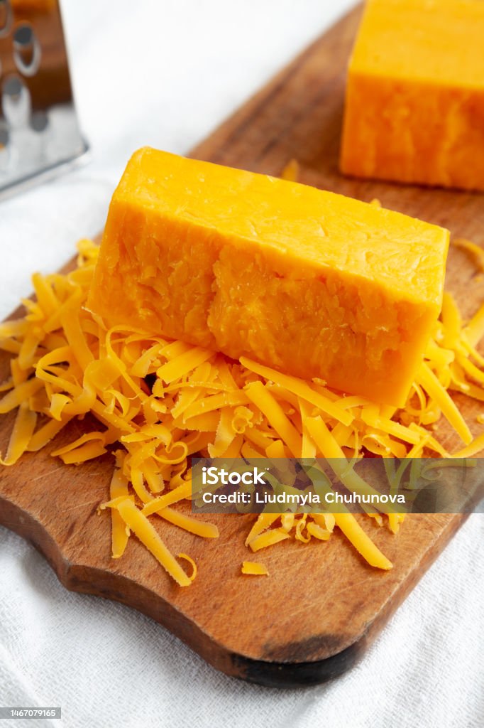 Rustic Cheddar Lumpy Shredded Sharp Cheddar Cheese On A Rustic Wooden Board Side View Stock ...