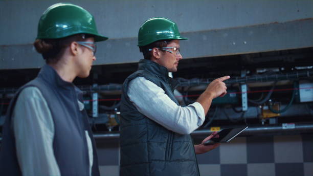 istock Agriculture supervisors inspecting manufacture facility together in uniform. 1467079269