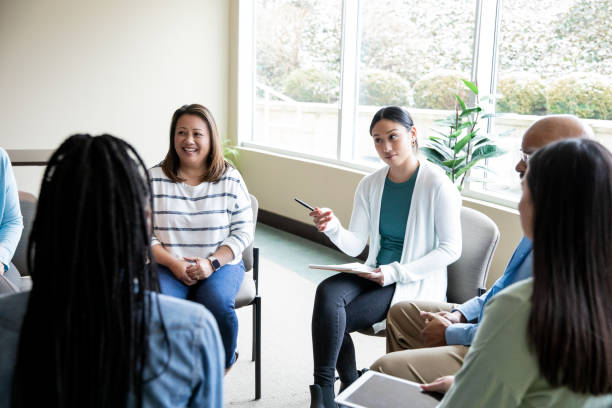 istock Support group of diverse individuals have discussion during meeting 1467079570