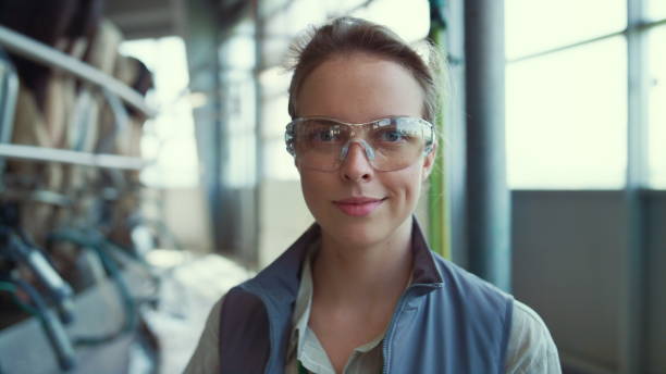 istock Closeup dairy farm worker in protective glasses posing at milking parlour alone. 1467081152