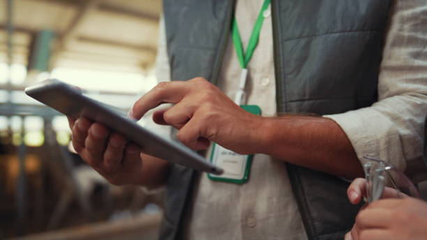 istock Farmer hands holding tablet computer closeup. Specialists discussing data in pad 1467083228