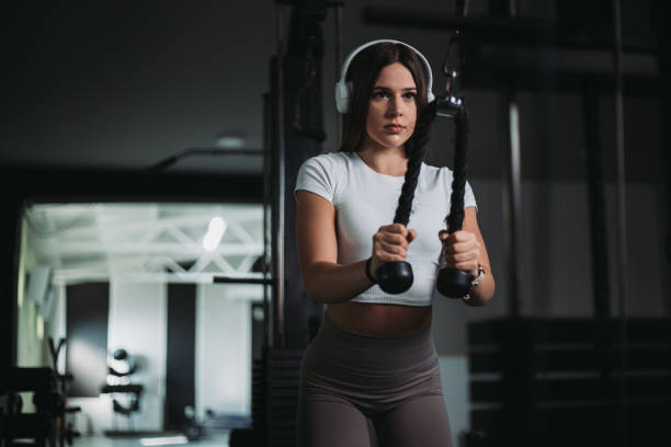 Beautiful young woman doing workout in gym. stock photo