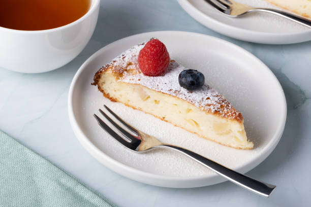 istock Slice of apple pie with powdered sugar, garnished with raspberries and blueberries 1467094620