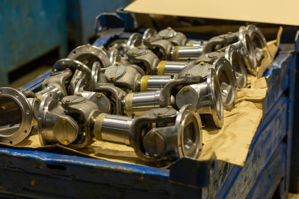 istock Cardan shafts and gimbal transmissions laying in box during production process. 1467095017