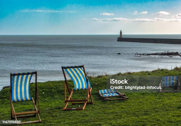Deck Chairs Blowing In The Wind Stock Photo - Download Image Now - Beach, Chair, Cliff