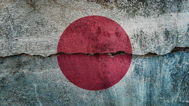 istock Japan flag on cracked wall. Earthquake or drought concept 1467100396
