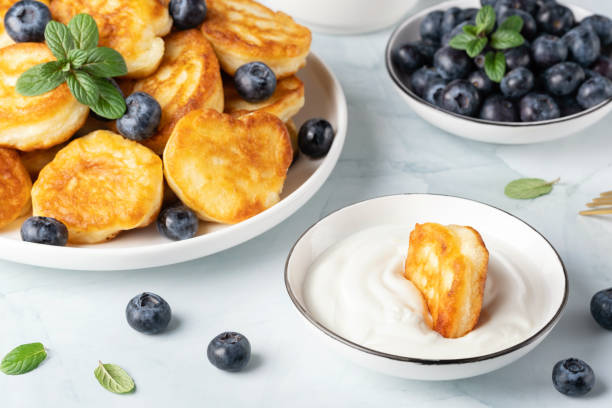 istock Homemade mini pancakes with sour cream and blueberries 1467100554