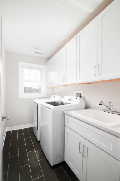 istock A laundry room with a dark grey floor and white appliances. 1467101802