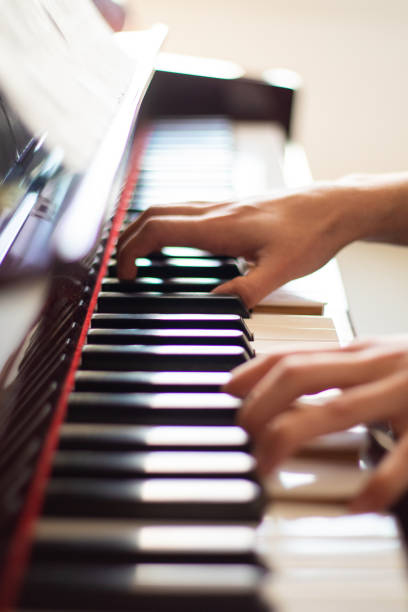 istock person playing the piano 1467103776