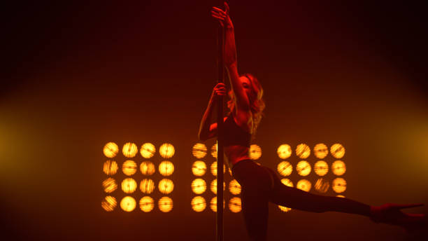 istock Pole dancer making sensual performance in nightclub. Fit lady dancing. 1467107808