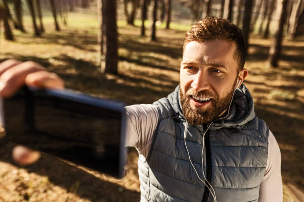 istock Young smiling runner man on a morning routine making selfie 1467108833