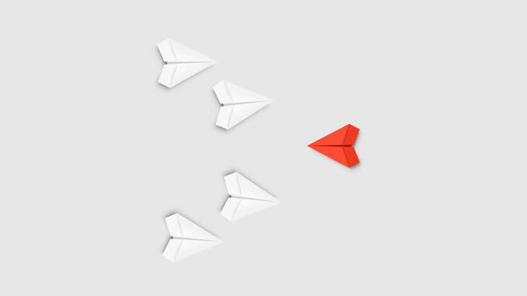 Red paper plane flying against white