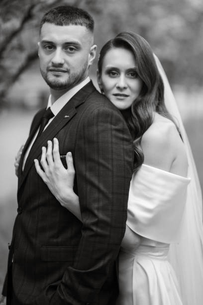 istock newlyweds walk in the park among cherry blossoms 1467114013