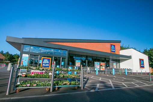 Potted Plants at Aldi Supermarket on Otford Road in Sevenoaks at Kent, England, with commercial signs visible.