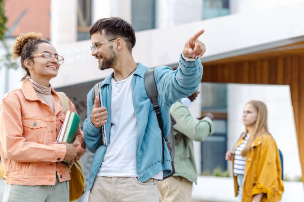 istock Students talking and waiting a bus on a bus stop 1467114528