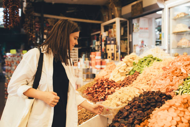 istock Woman on bazaar exploring spices, nuts and delight. 1467115781